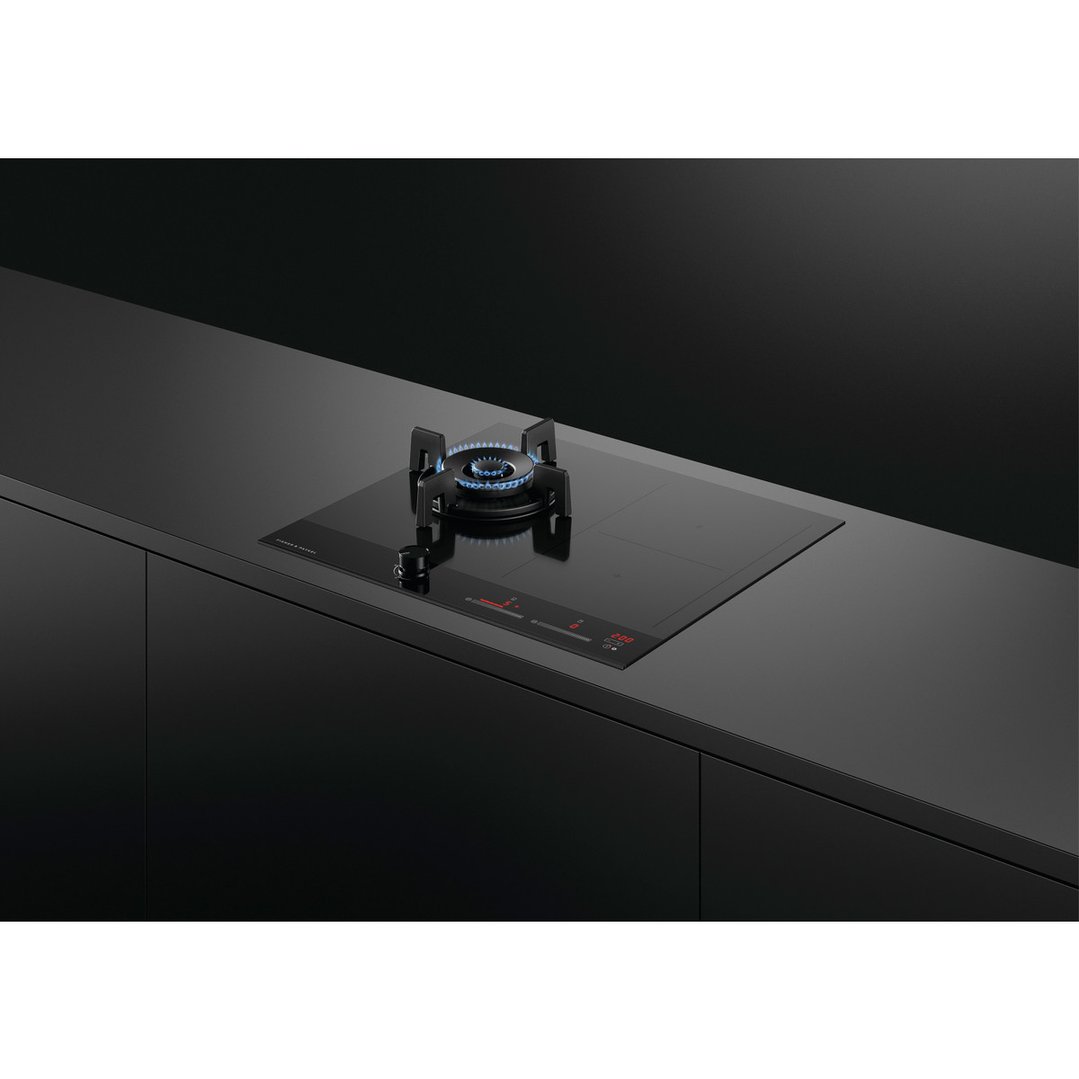 Hybrid cooktop with gas burner and electric zones in a modern dark kitchen