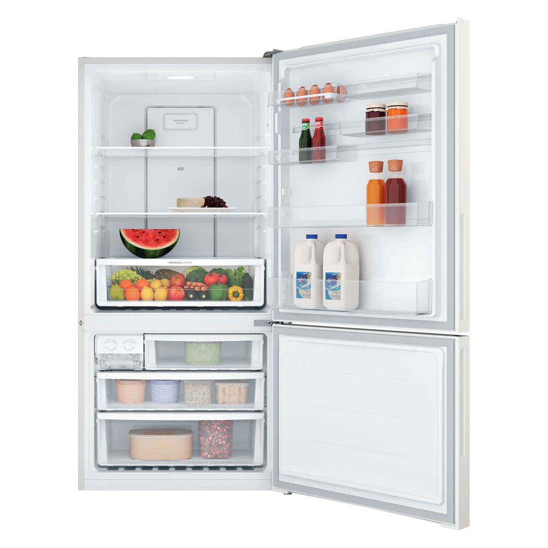 Open white bottom mount fridge with food items inside on a white background