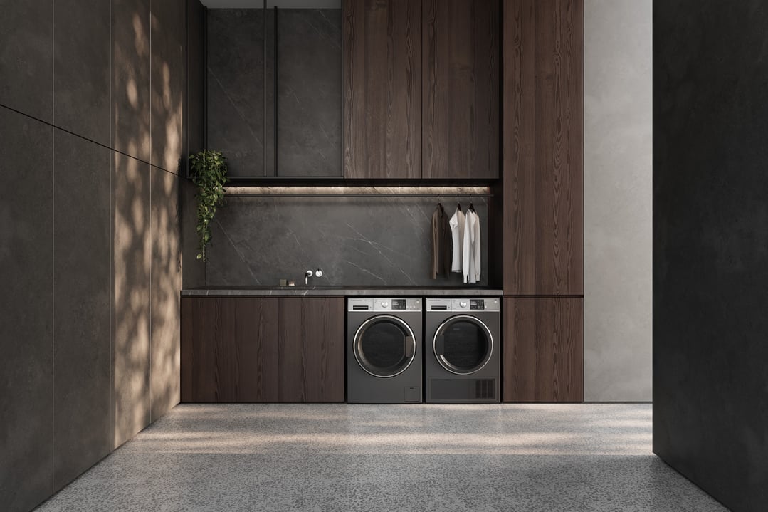 Two front-loading washing machines in a modern laundry room with dark wood cabinetry