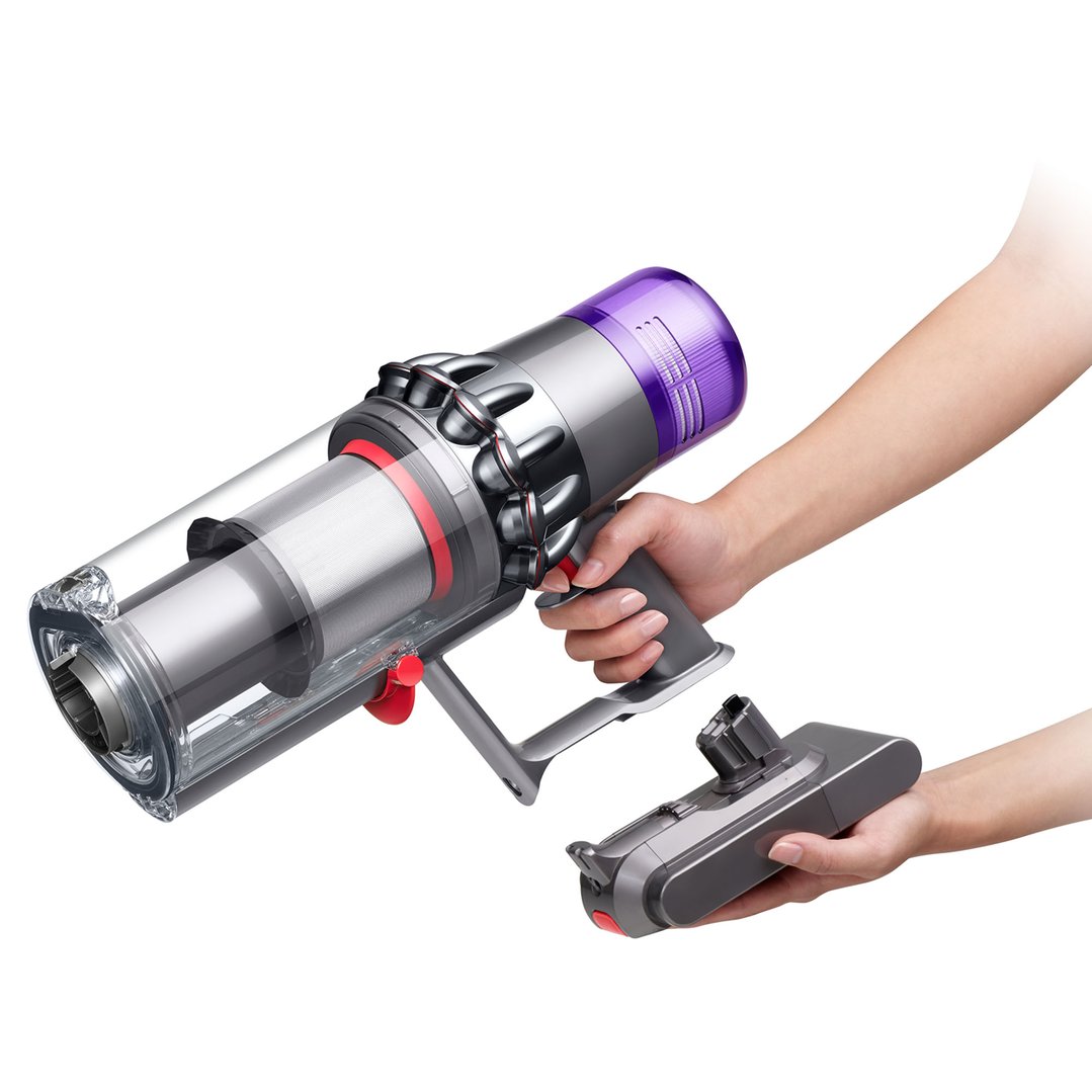 Hands holding a Dyson V11 Stick Vacuum and an attachment