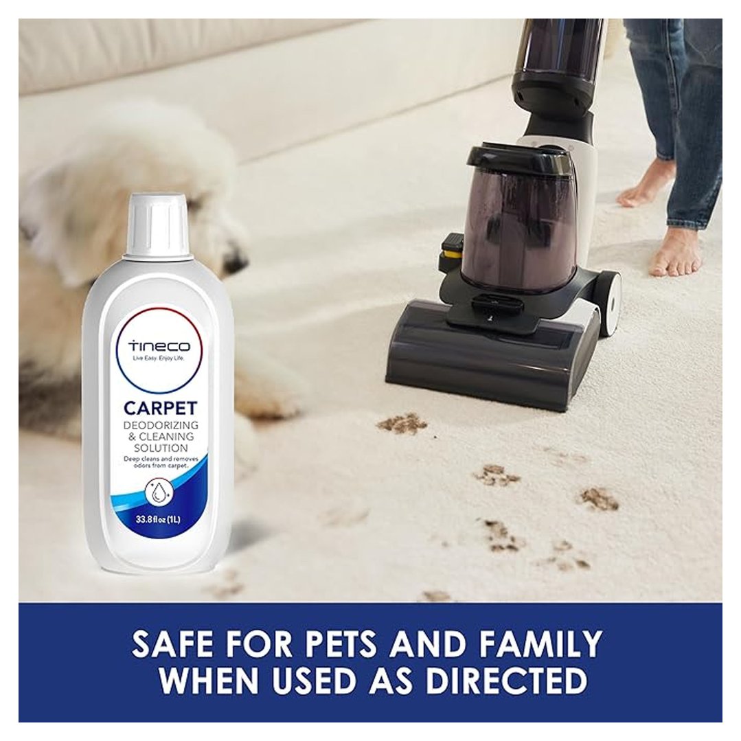 Carpet cleaning solution bottle next to a carpet cleaner and dog on a carpet