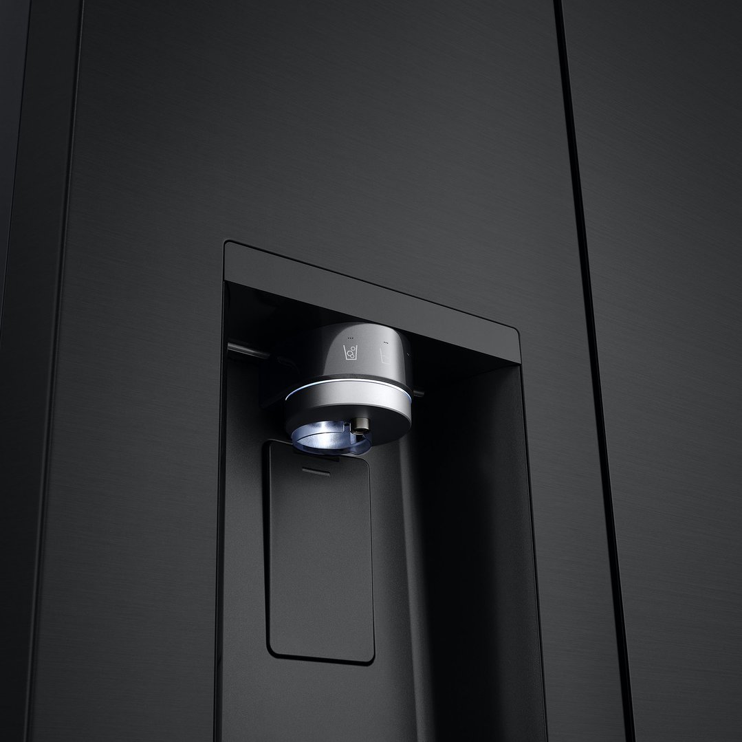 Close up of a matte black fridge's water and ice dispenser