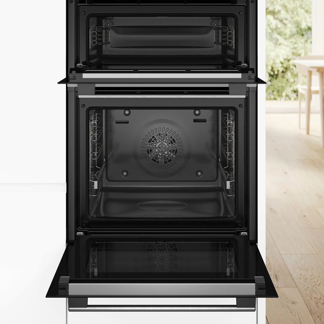 Built-in double oven with doors open in a kitchen setting