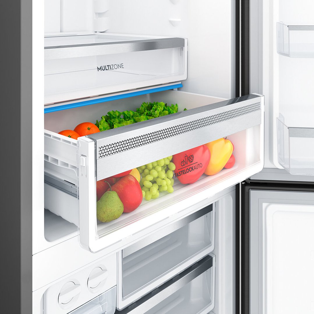 Open fridge drawer filled with fresh fruits and vegetables