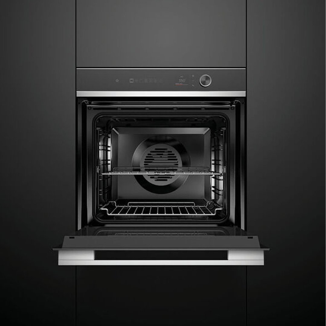 Black built-in oven with door open, showing interior racks and fan