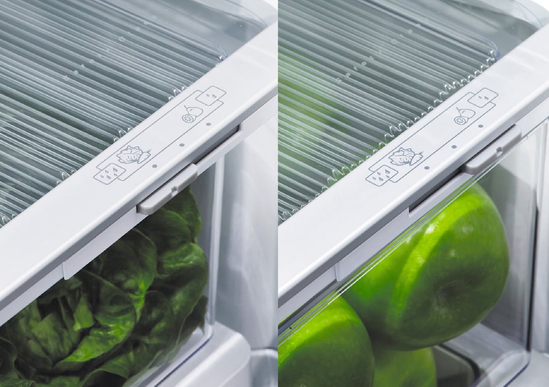 Close up of refrigerator crisper drawer with lettuce and apples