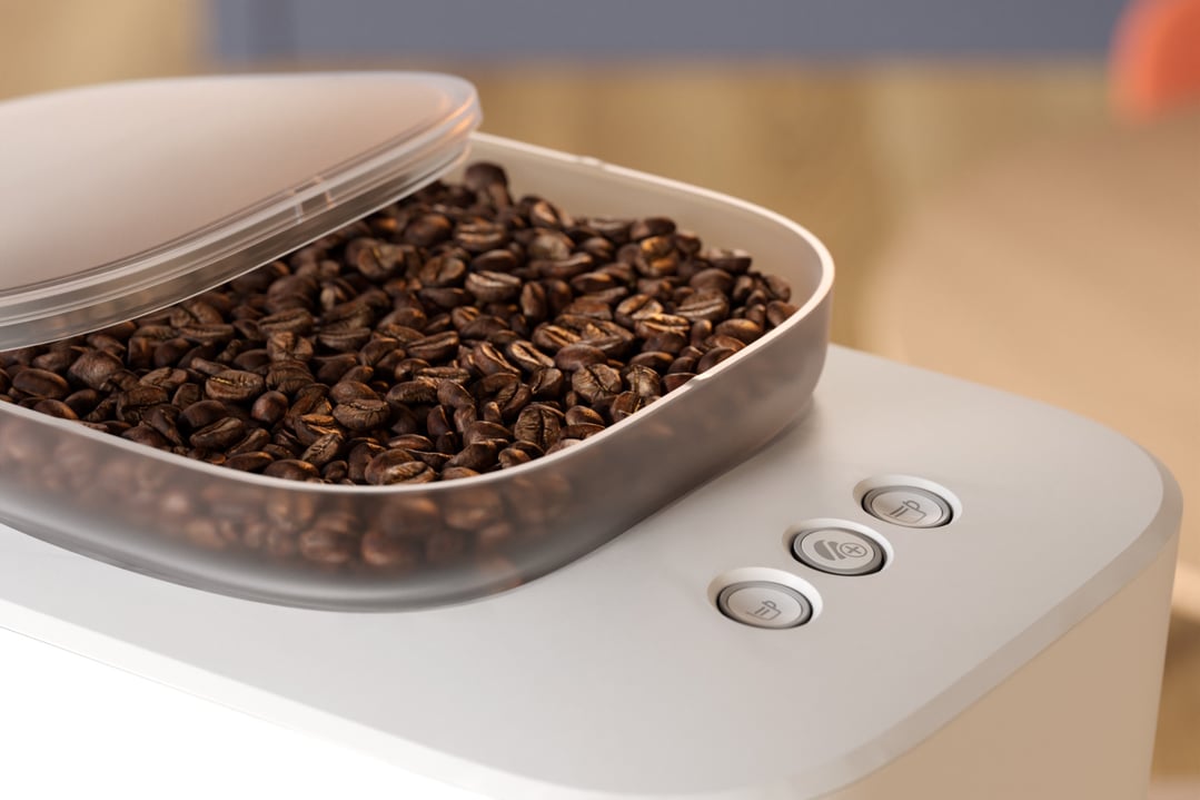 Close up of coffee beans in the hopper of a white espresso machine