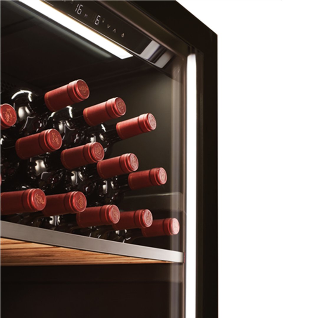 Close up of a wine cabinet interior with multiple bottles of red wine