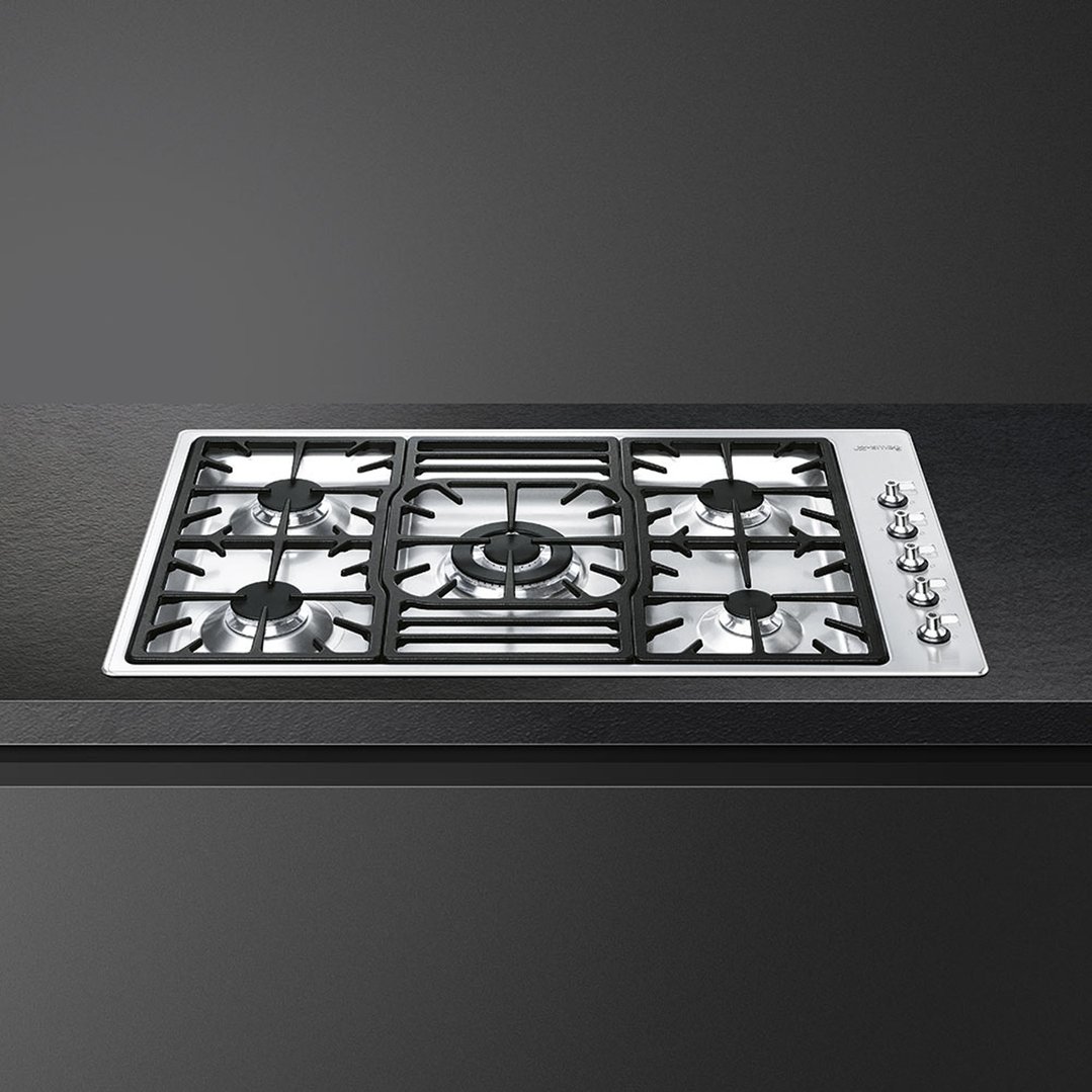 SMEG 90cm gas cooktop with five burners built into a dark countertop