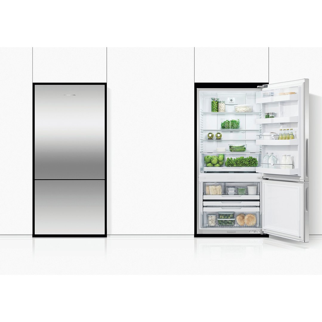 Stainless steel refrigerator freezer in a modern kitchen, one door open