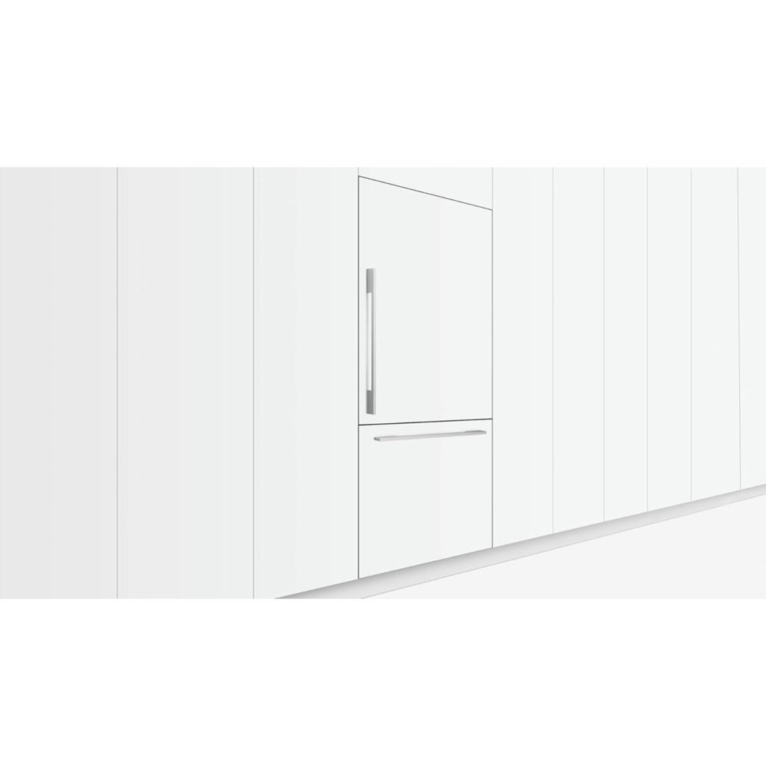Integrated refrigerator freezer with two doors in a white kitchen setting