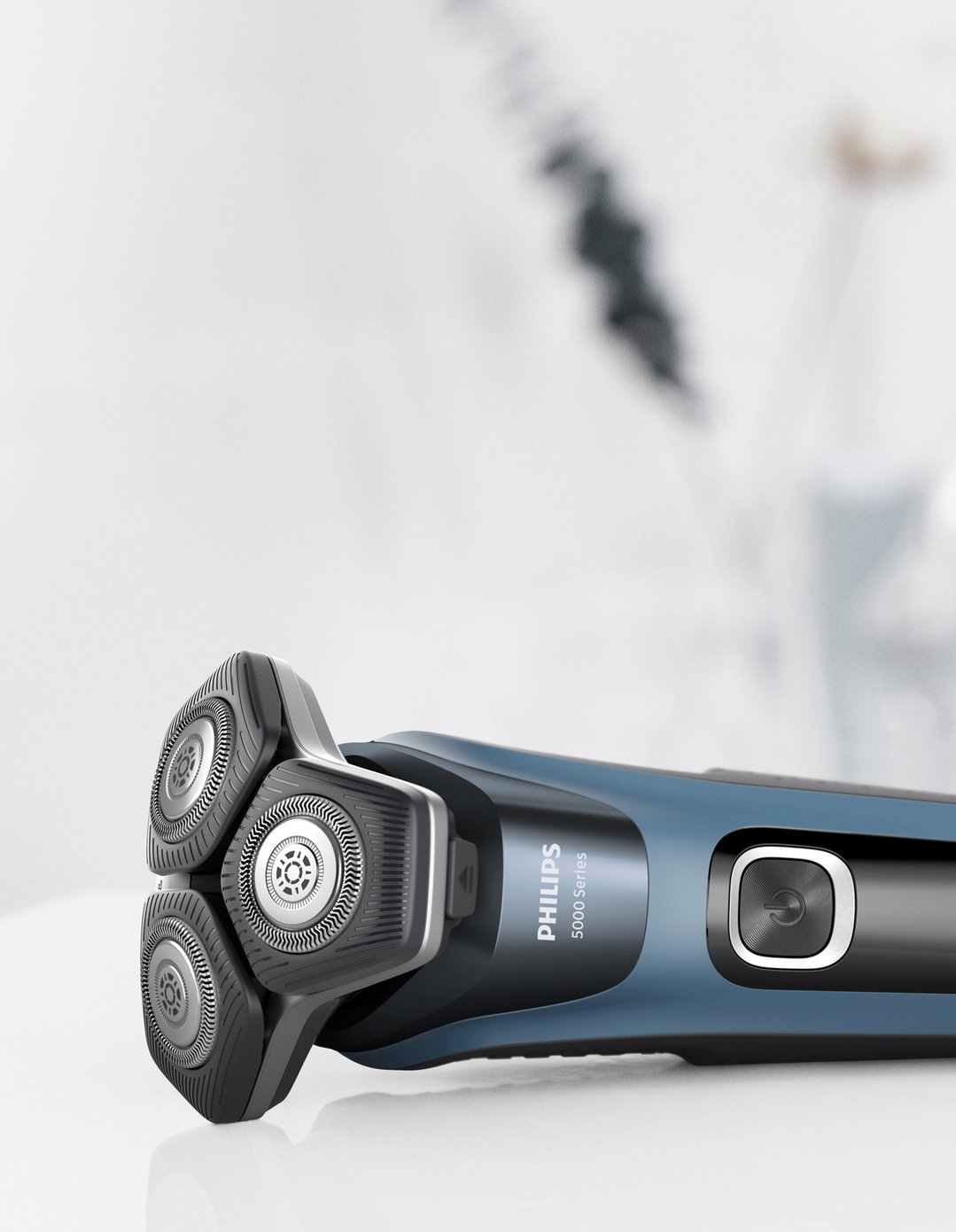 Philips Series 5000 Shaver with three rotary blades on a white surface