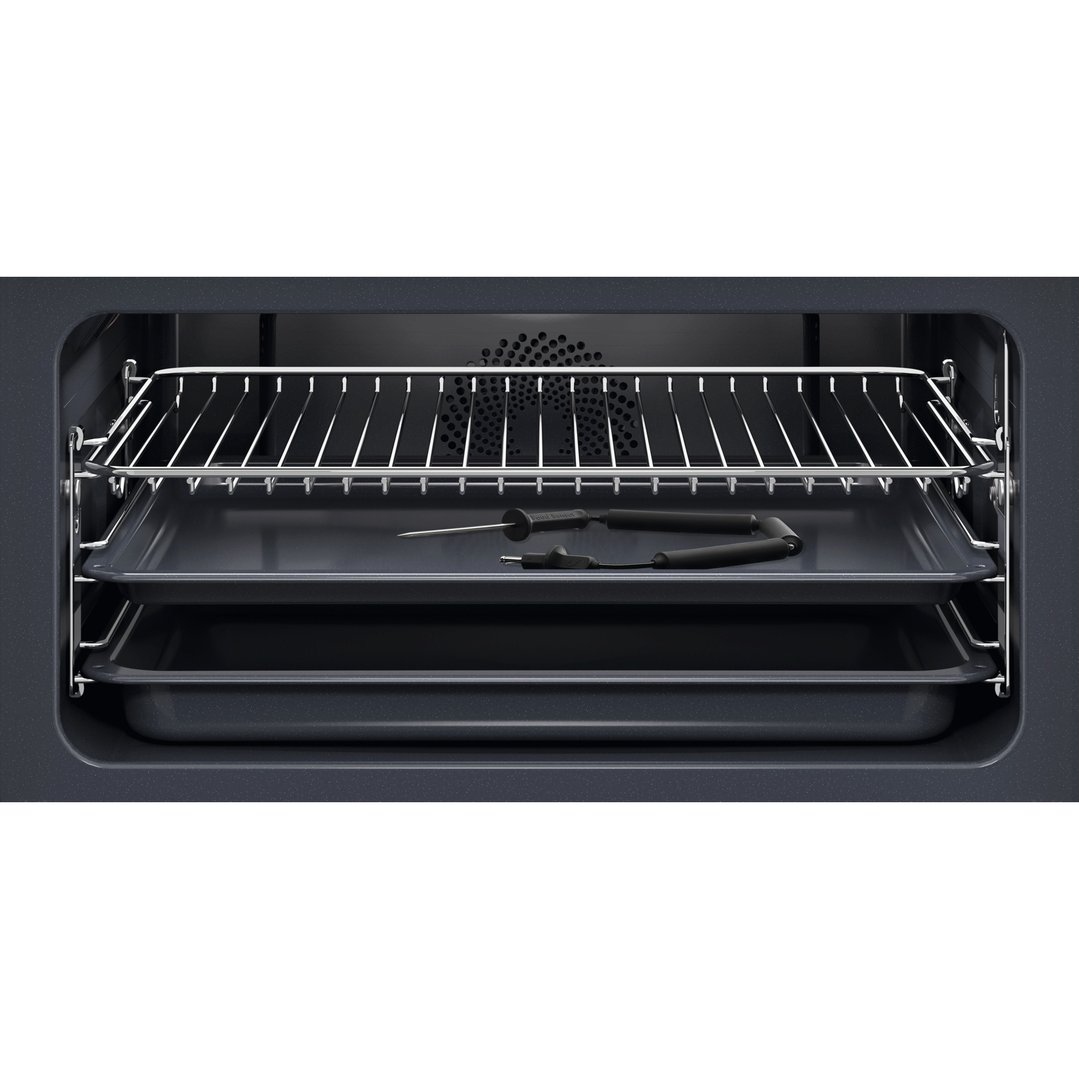 Interior view of an oven with a wire rack, two baking trays, and a food sensor