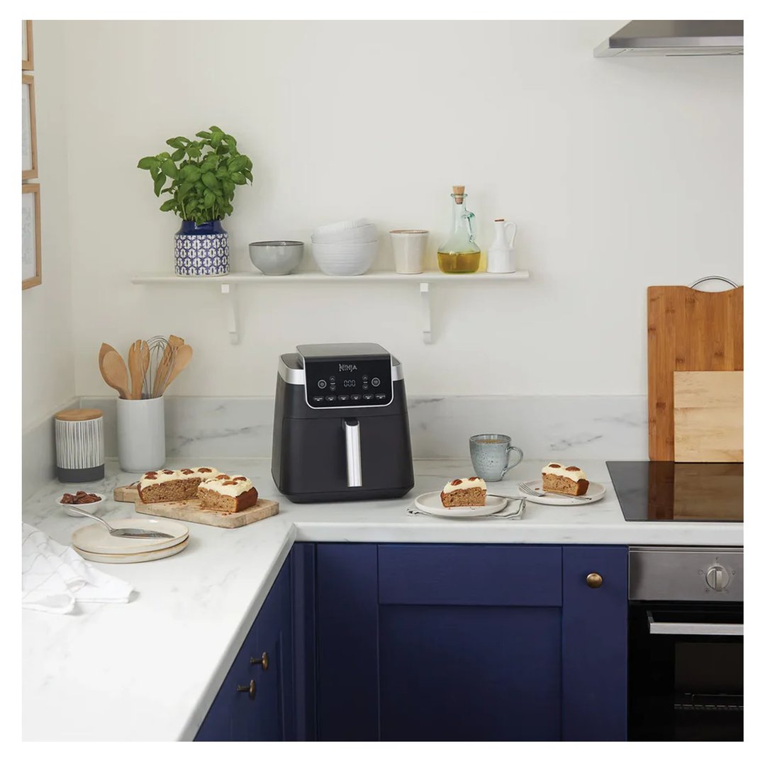 Black Ninja Air Fryer Pro XL 6.2L on a kitchen counter with cake