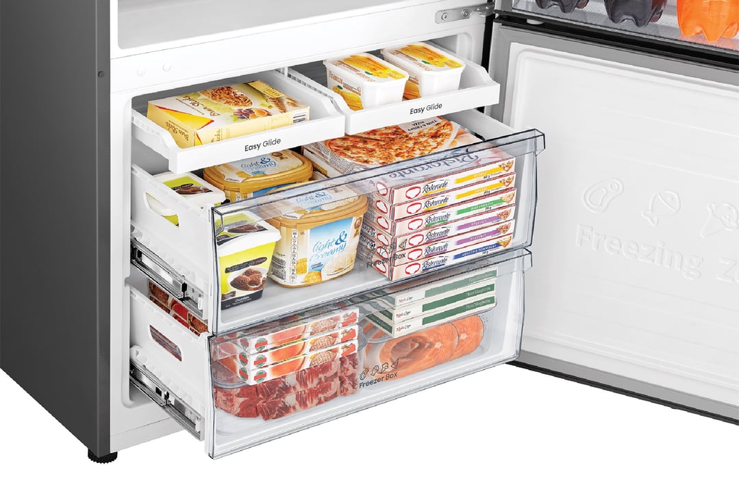 Open bottom mount fridge freezer drawers filled with various frozen foods