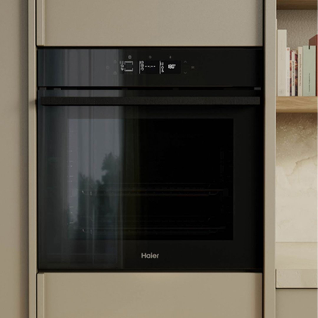 Built-in oven with a black glass door and digital display in a kitchen setting