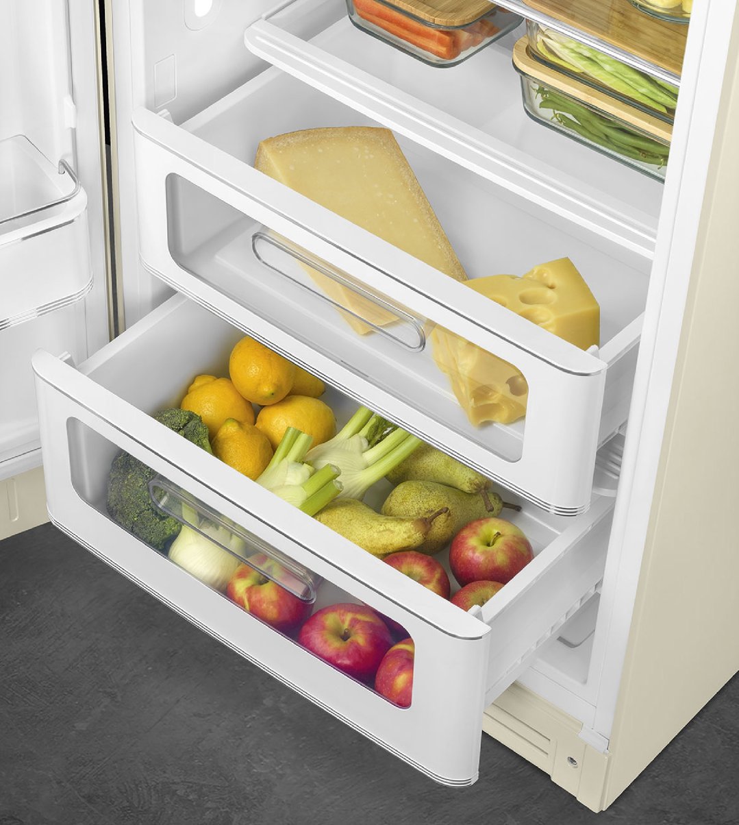 Open refrigerator with drawers full of fruits, vegetables, and cheese