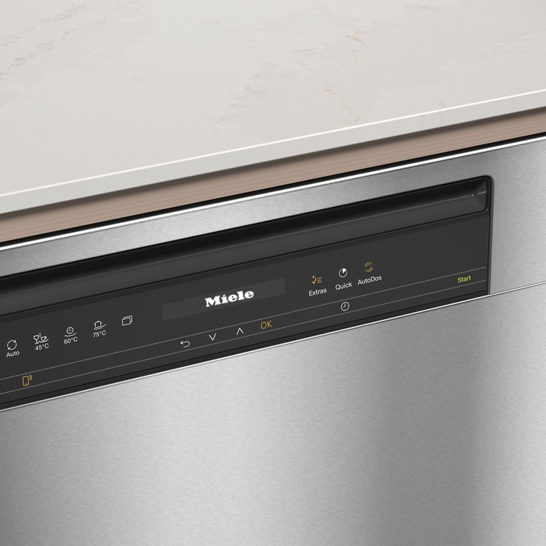 Close-up of a Miele dishwasher control panel with a white countertop above