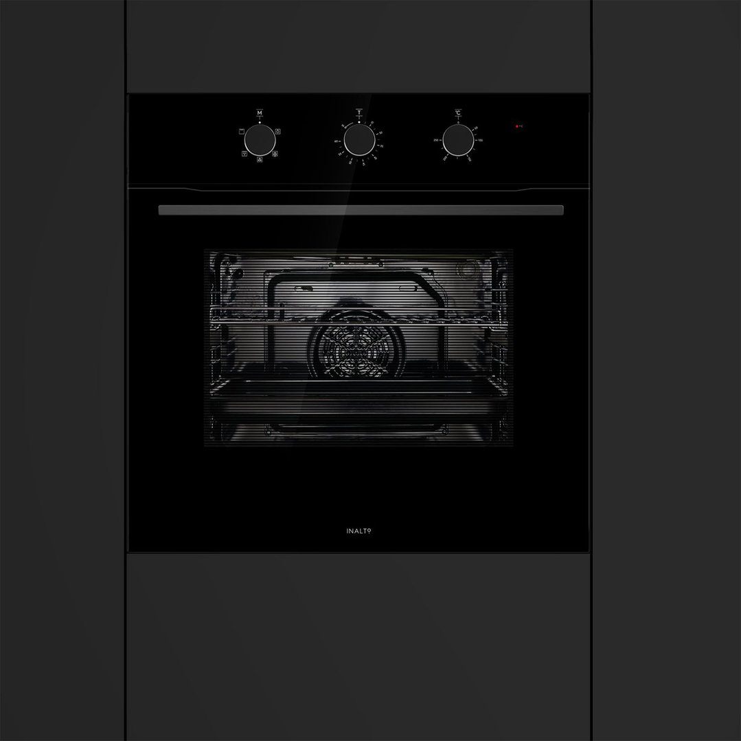 Black built-in oven with three control knobs in a dark kitchen setting