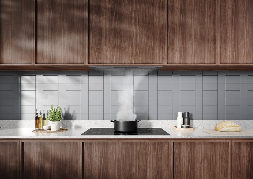 Integrated rangehood above a cooktop with a boiling pot in a modern kitchen