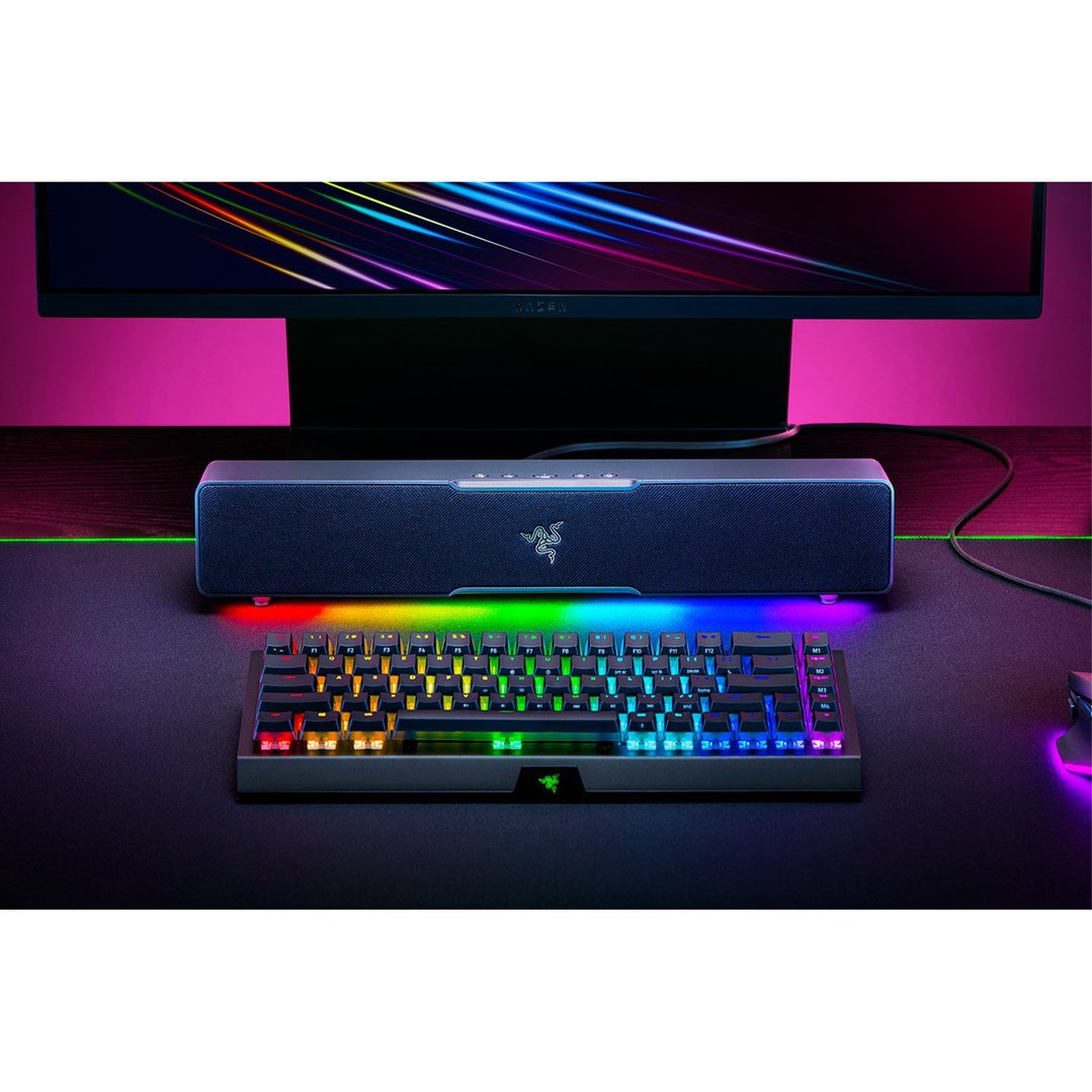 Razer Leviathan V2 X Gaming Soundbar and keyboard on a desk with a monitor