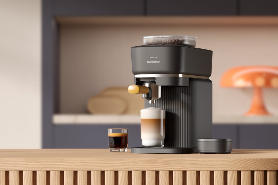 Philips Baristina Espresso Machine making coffee on a wooden kitchen counter
