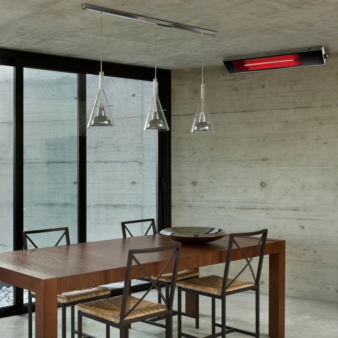 Infrared heater mounted on a concrete wall above a dining table