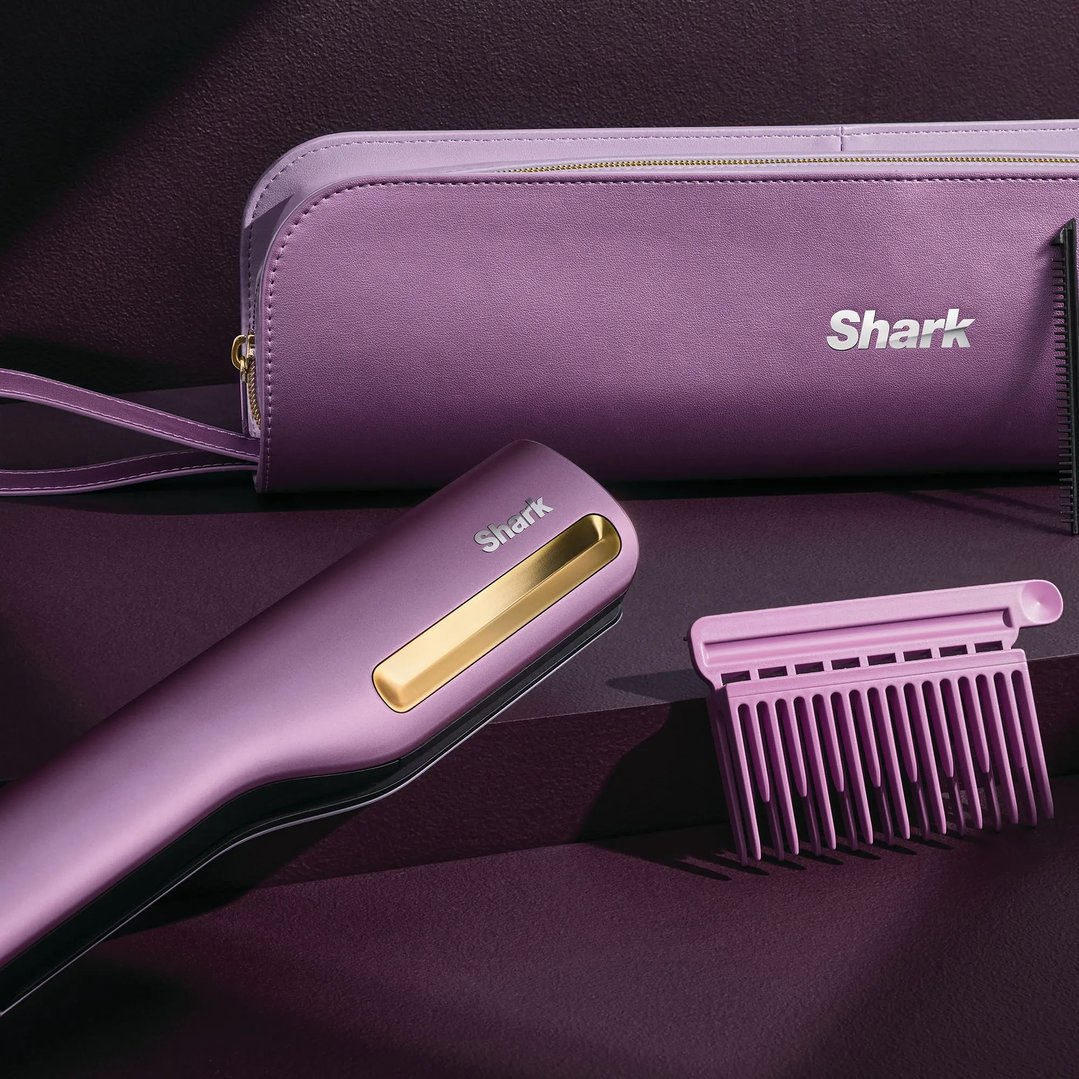 Purple Shark hair straightener, case, and comb on a dark purple surface