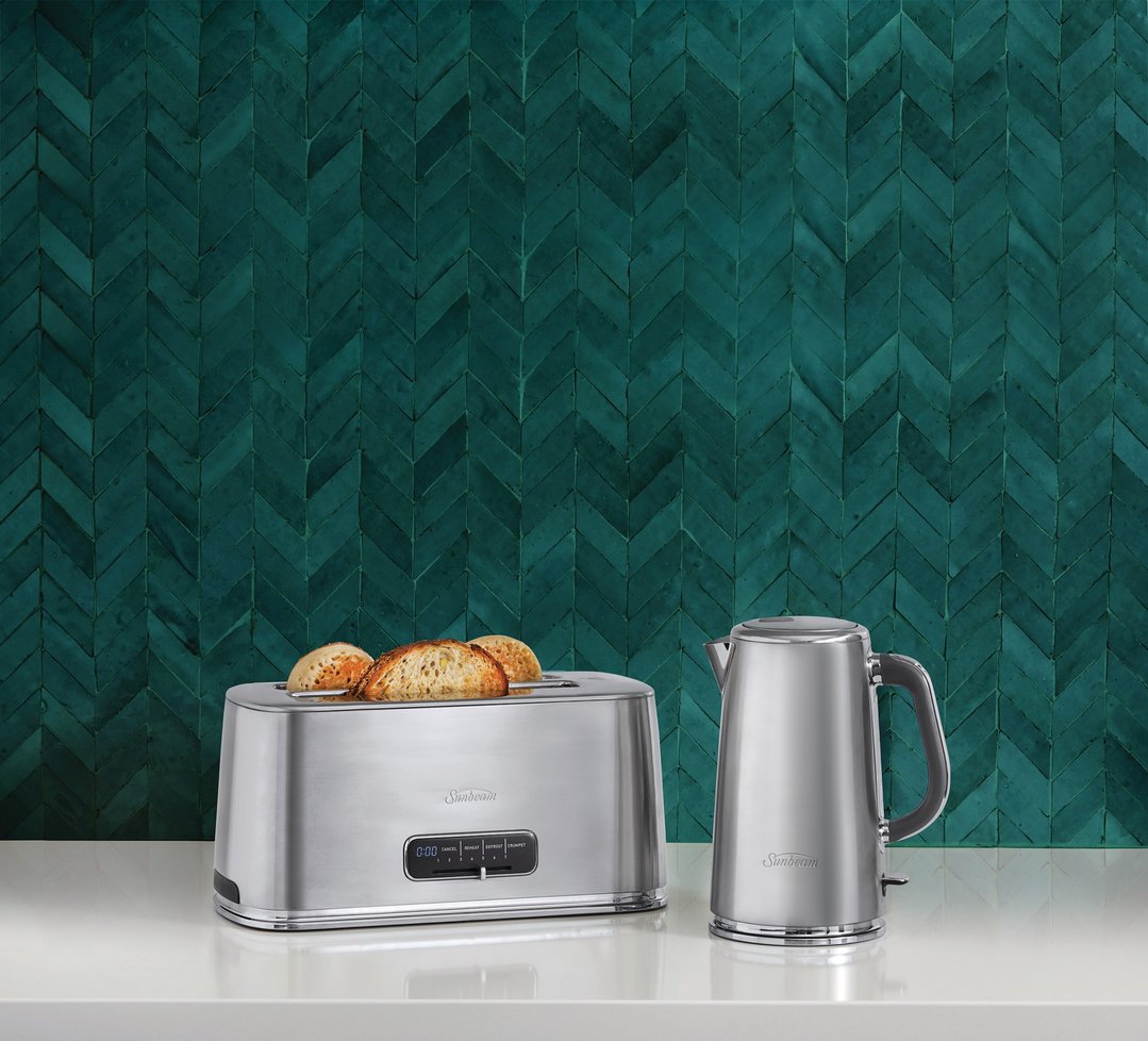Stainless steel toaster and kettle on a white benchtop against a teal tiled wall