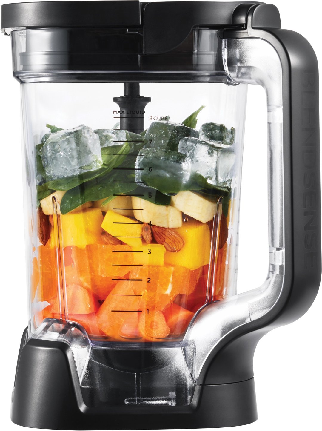 Blender jar filled with fruit, spinach, almonds, and ice cubes