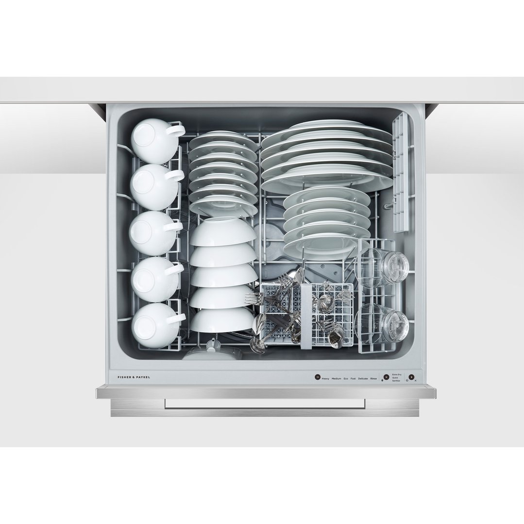 Open integrated double DishDrawer dishwasher filled with clean dishes and cups