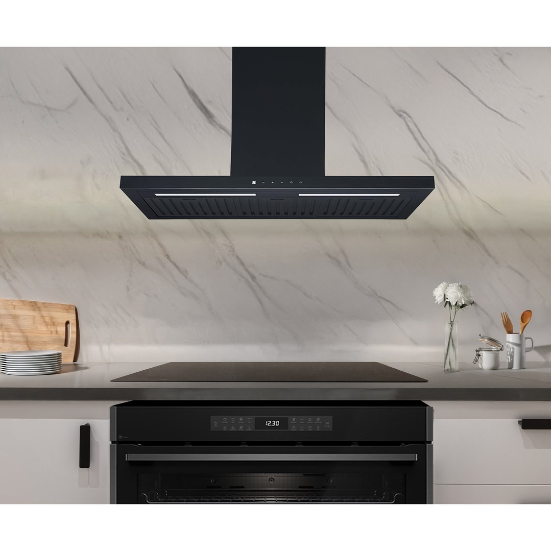 Black rangehood mounted above an induction cooktop in a modern kitchen