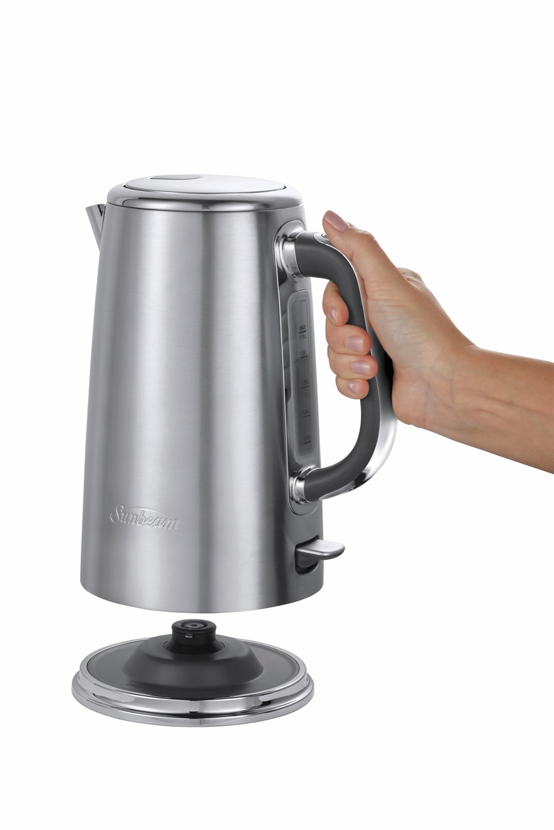 Hand holding a Sunbeam stainless steel kettle above its base