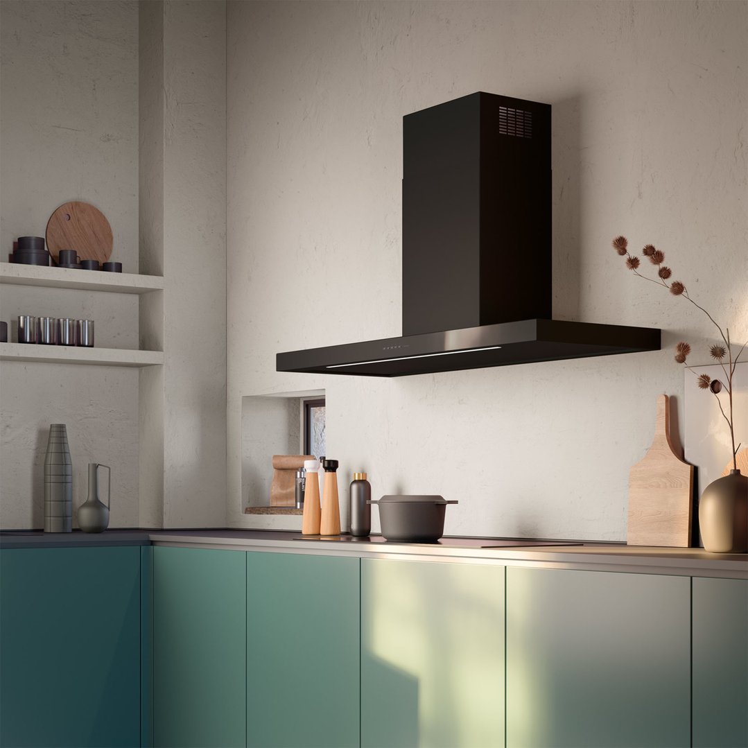 Black wall-mounted rangehood in a modern kitchen with green cabinets