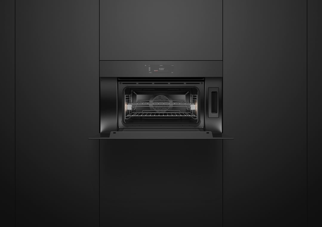 Built-in black glass combi-steam oven with door open in a dark kitchen