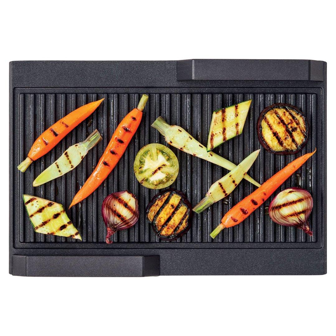 Griddle plate with grilled vegetables including carrots, zucchini, eggplant, and onion