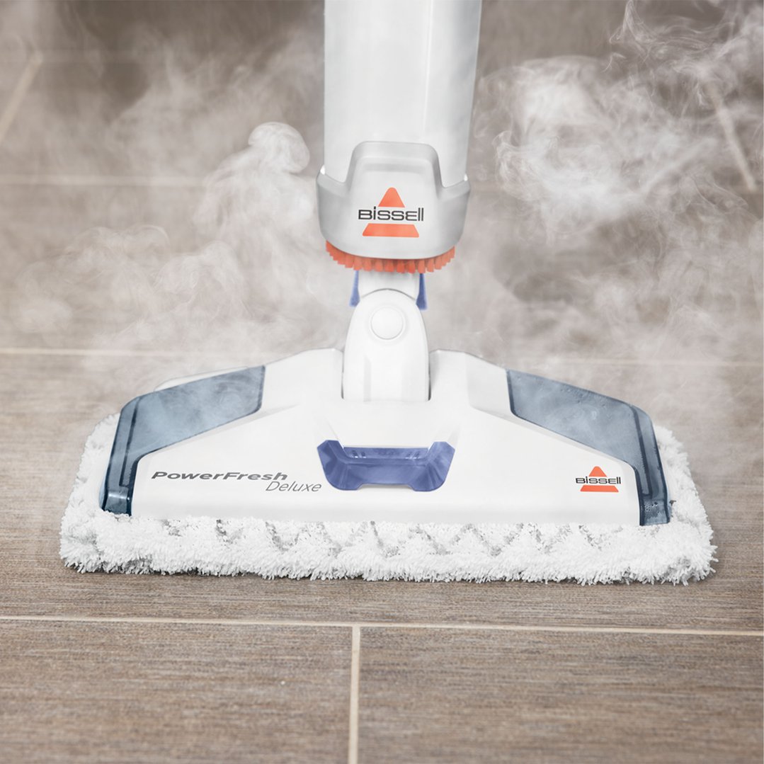 Bissell PowerFresh Deluxe steam mop cleaning a tiled floor with steam