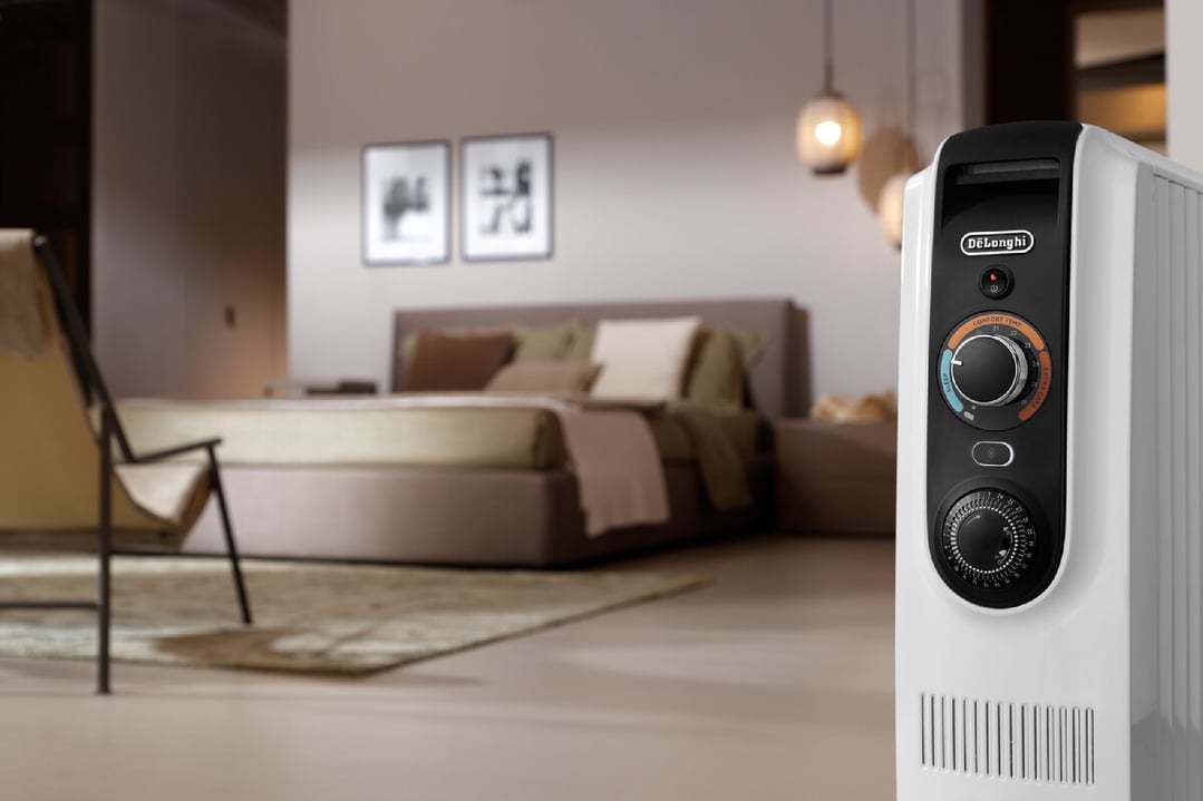 DeLonghi Dragon Easy Tronic oil column heater in a bedroom setting