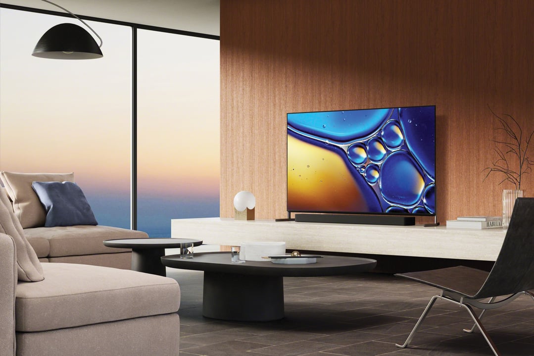 A SONY TV on a stand in a modern living room with a large window