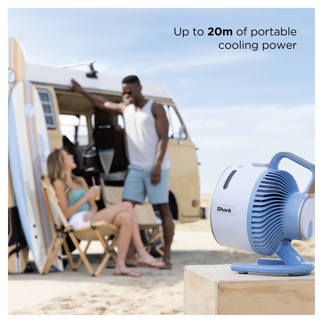 Shark FlexBreeze HydroGo misting portable fan on a wooden box at the beach