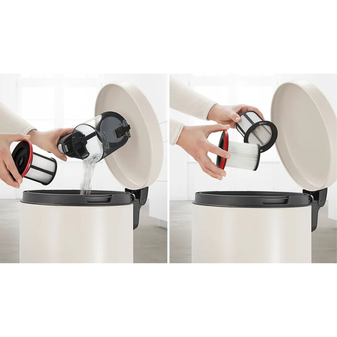 Hands emptying dust from a vacuum cleaner into a trash can