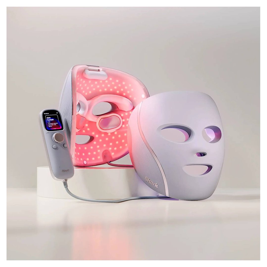 Two Shark LED face masks and a remote control on a white surface
