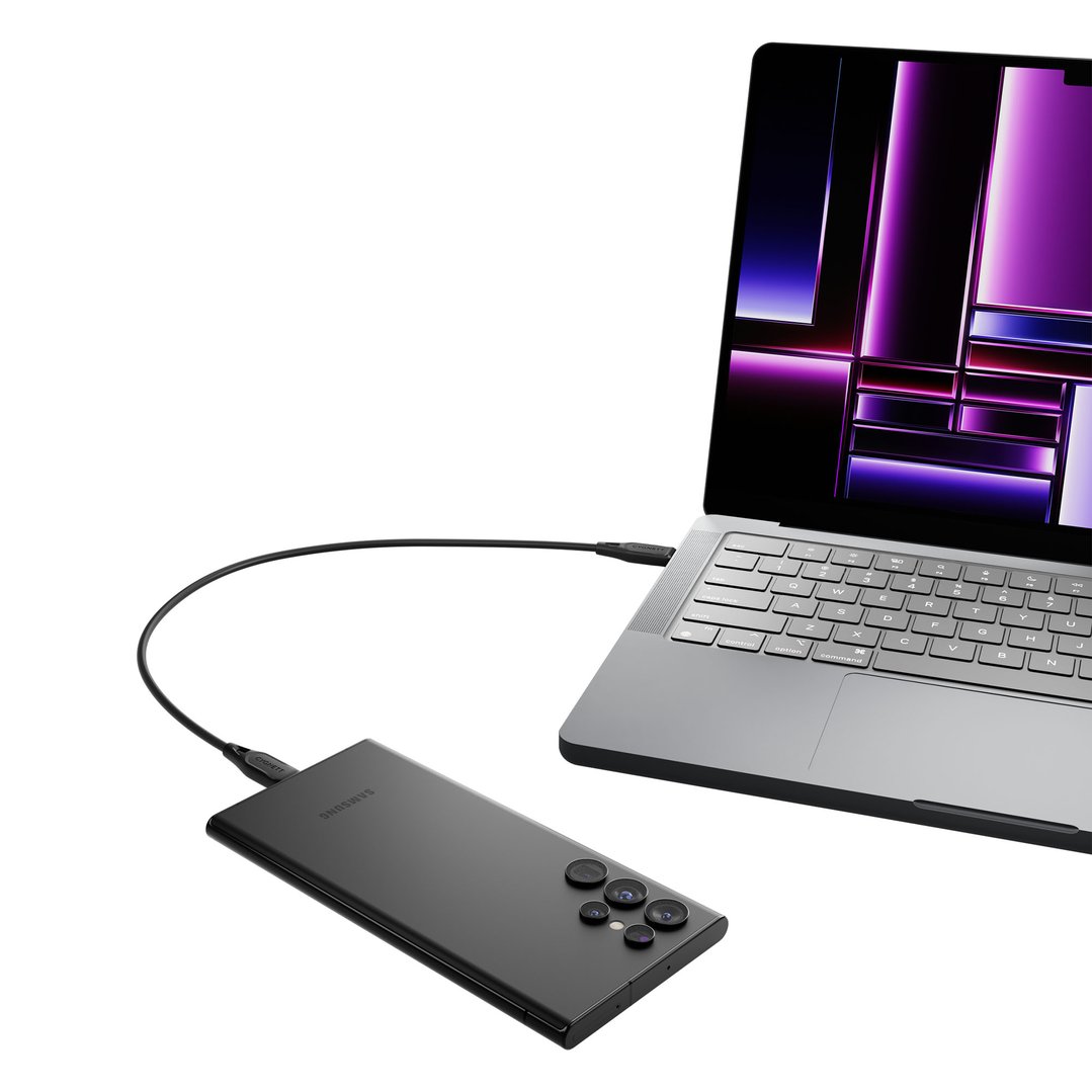 Black USB-C to USB-C cable connecting a laptop and a smartphone
