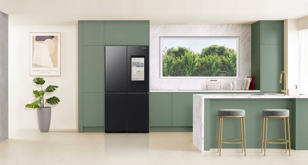 Black Samsung Family Hub refrigerator in a modern kitchen with green cabinets and island