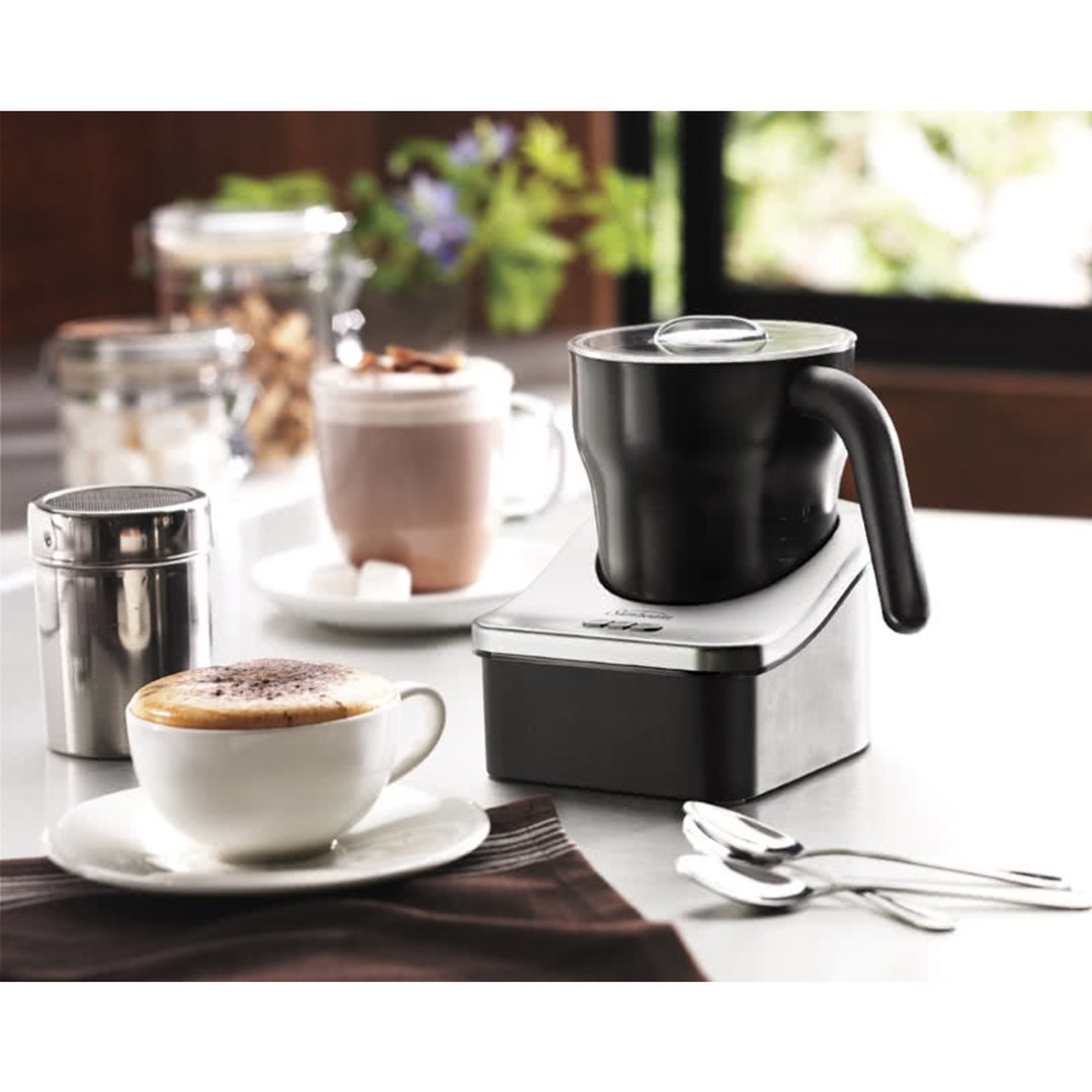 Sunbeam Cafe Creamy Automatic Milk Frother on a counter with coffee and hot chocolate