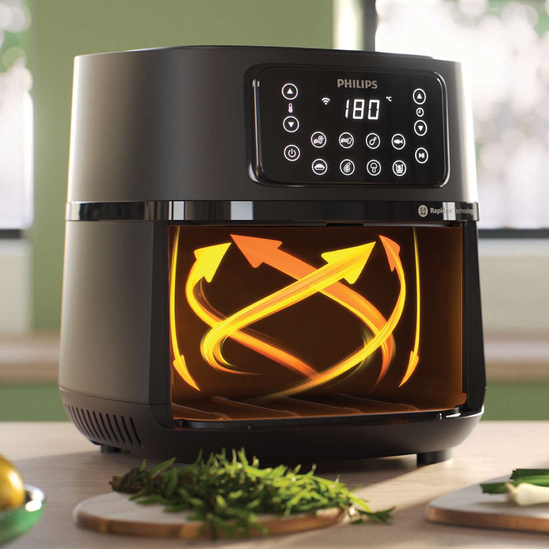 Philips airfryer on a wooden counter with herbs and lemon