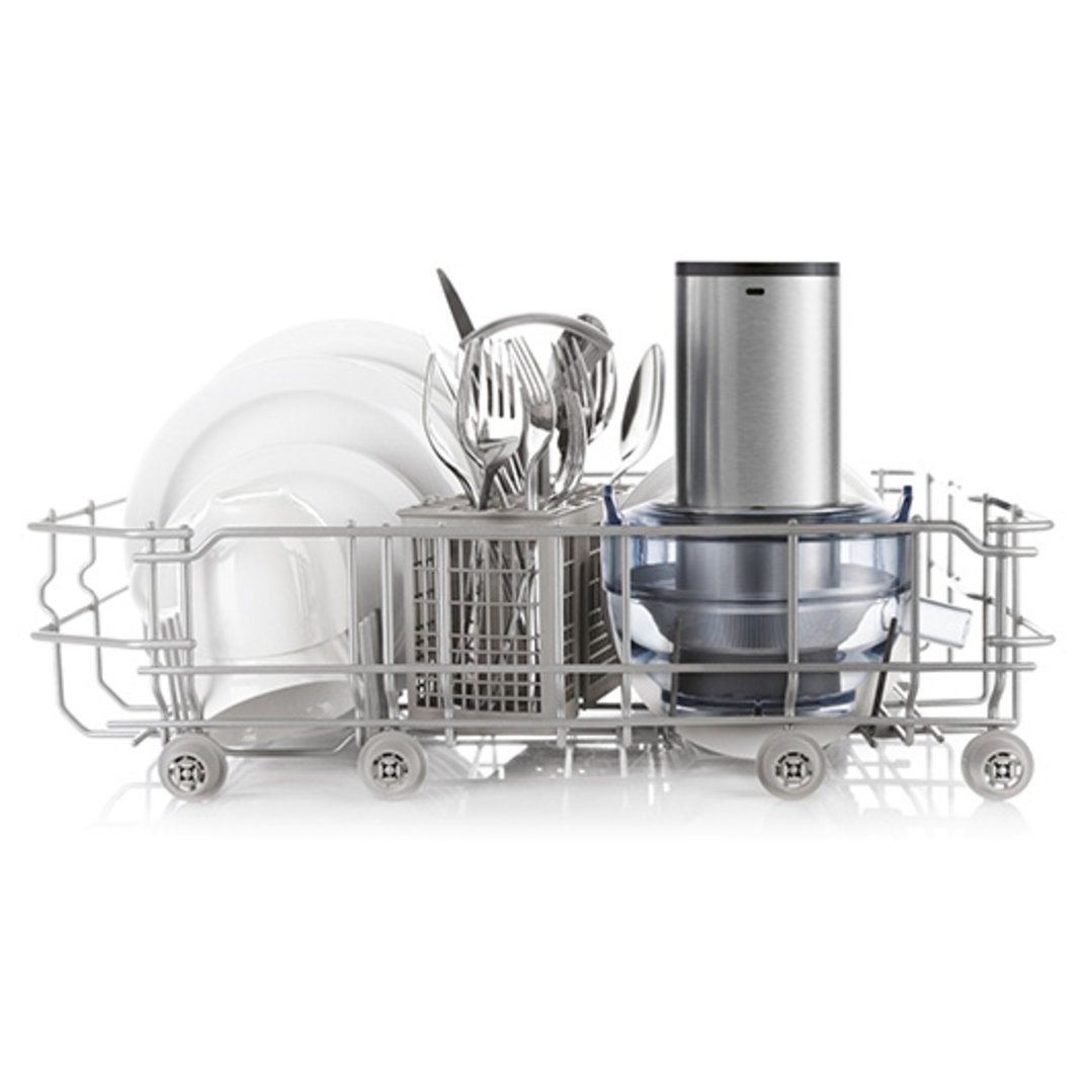 Blender and juicer attachment in a dishwasher rack with dishes and cutlery