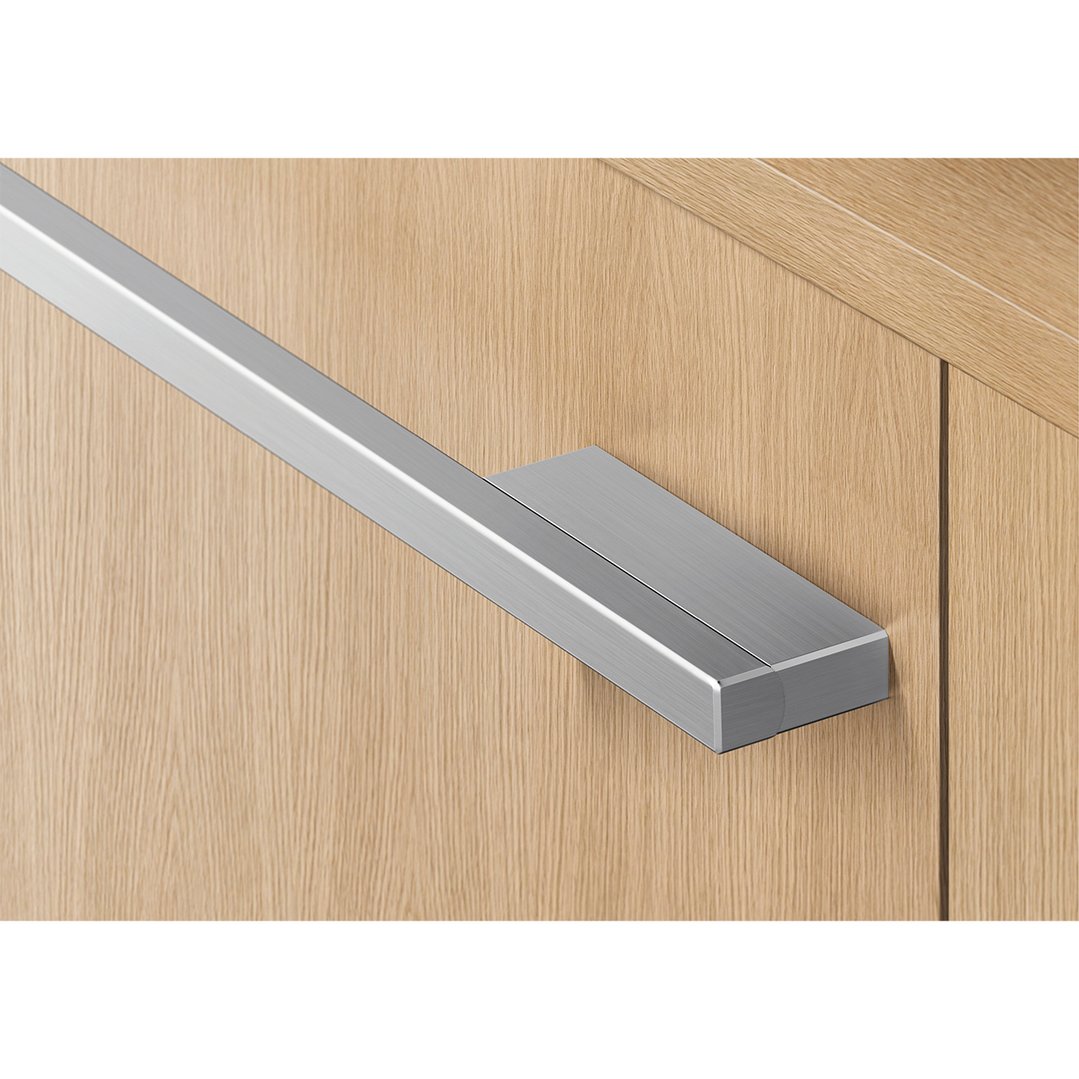 Close up of a stainless steel handle on a wooden dishwasher panel
