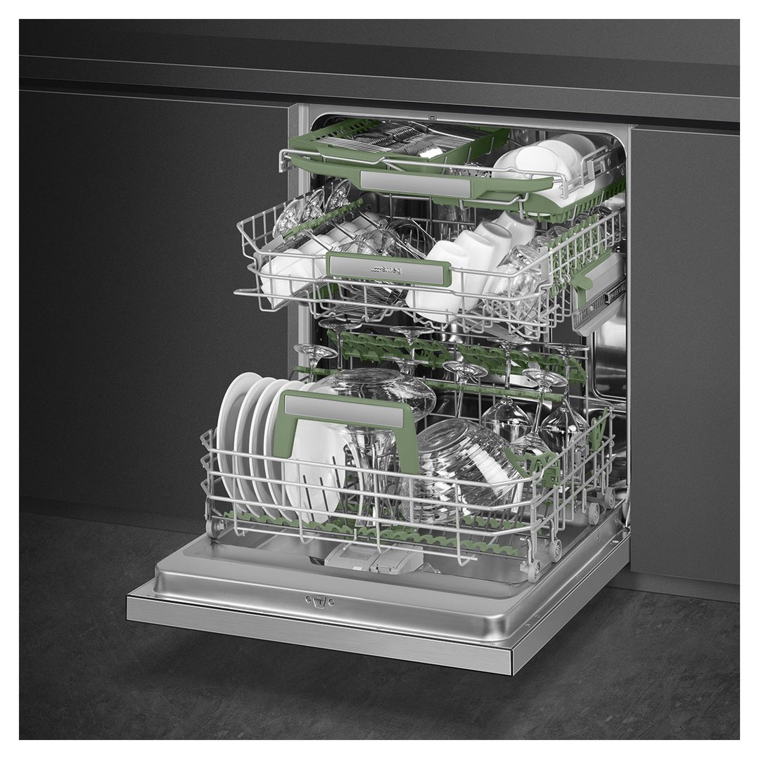 Open stainless steel dishwasher with green racks filled with dishes in a dark kitchen