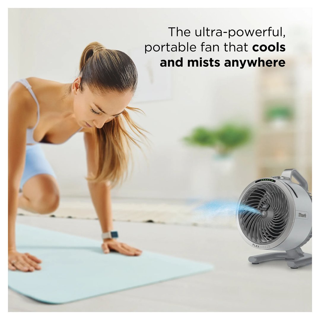 Woman exercising on a mat with a Shark FlexBreeze fan cooling her